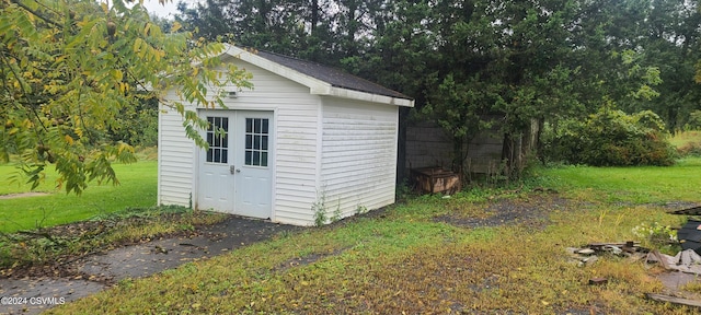 view of outdoor structure featuring a lawn