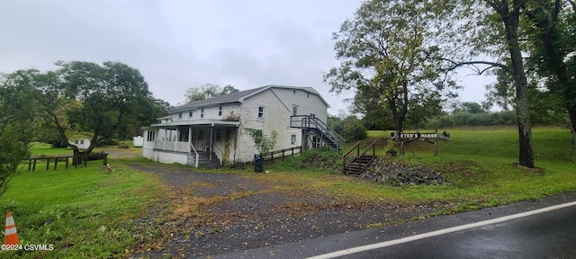 view of side of property featuring covered porch