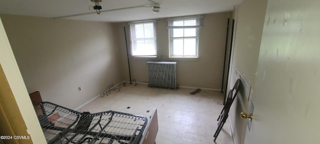 unfurnished room featuring radiator