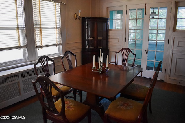 dining room with dark hardwood / wood-style flooring and radiator