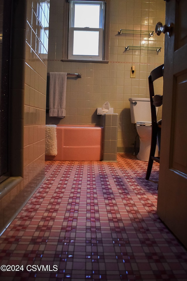 bathroom with tile walls, toilet, and tile patterned floors