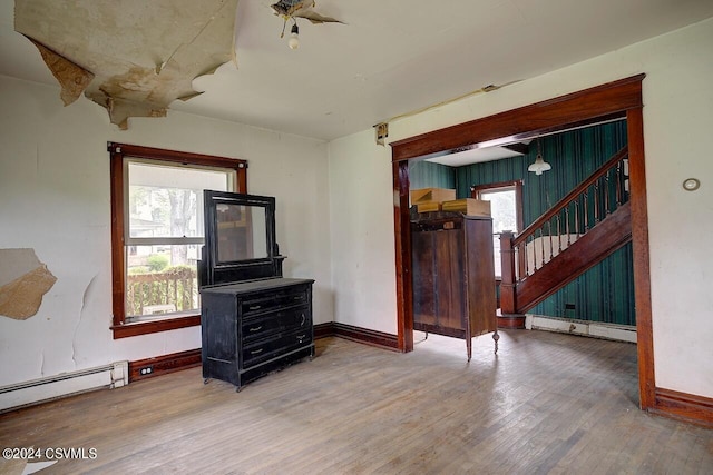 spare room with a baseboard heating unit and hardwood / wood-style flooring