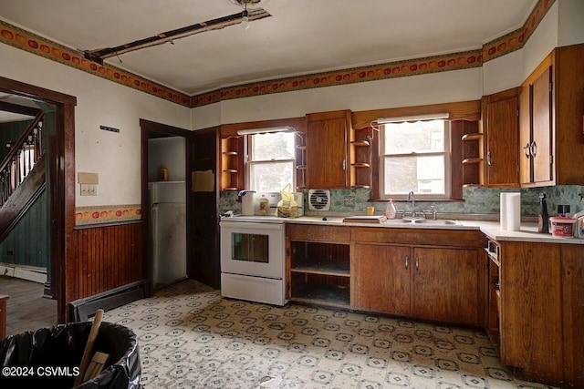 kitchen featuring white range with electric cooktop, a baseboard radiator, tasteful backsplash, and sink