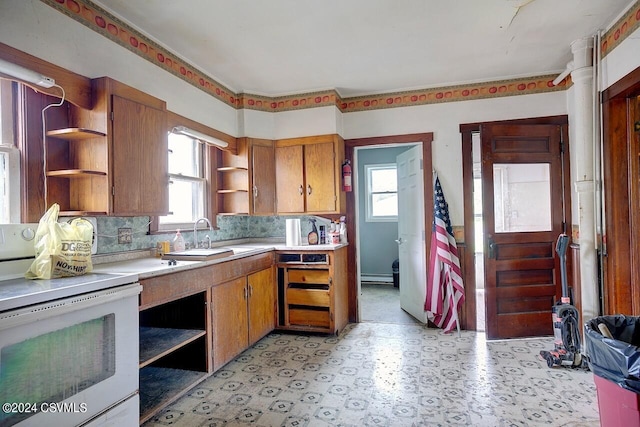 kitchen with a baseboard heating unit, tasteful backsplash, light tile patterned flooring, sink, and white electric range