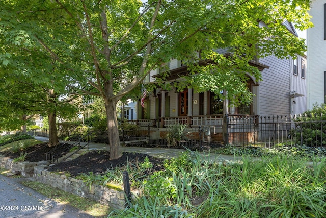 obstructed view of property with a porch