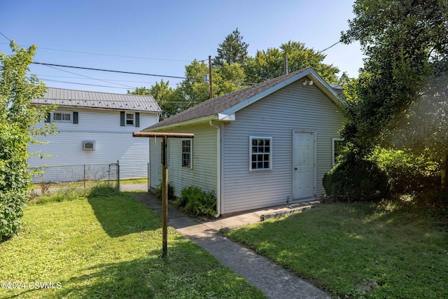 back of property featuring a yard