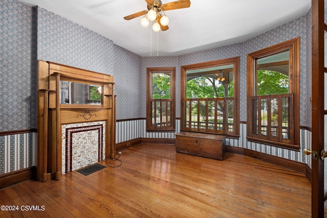 unfurnished living room with hardwood / wood-style flooring and ceiling fan