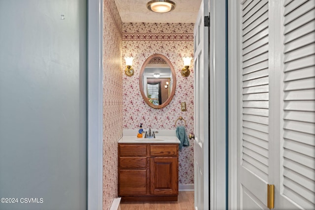 bathroom featuring hardwood / wood-style flooring and vanity