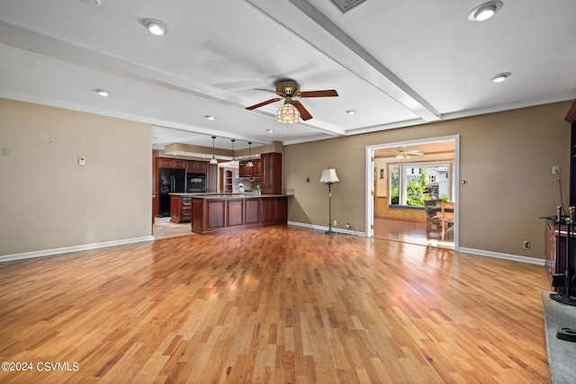 unfurnished living room with ceiling fan, light hardwood / wood-style floors, and beamed ceiling