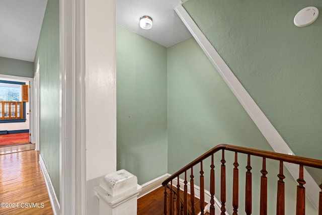 stairs featuring hardwood / wood-style flooring