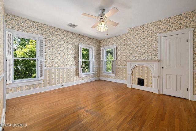 unfurnished living room with a healthy amount of sunlight and wood-type flooring