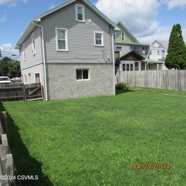 rear view of house with a lawn