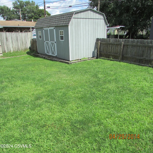 view of outdoor structure featuring a lawn