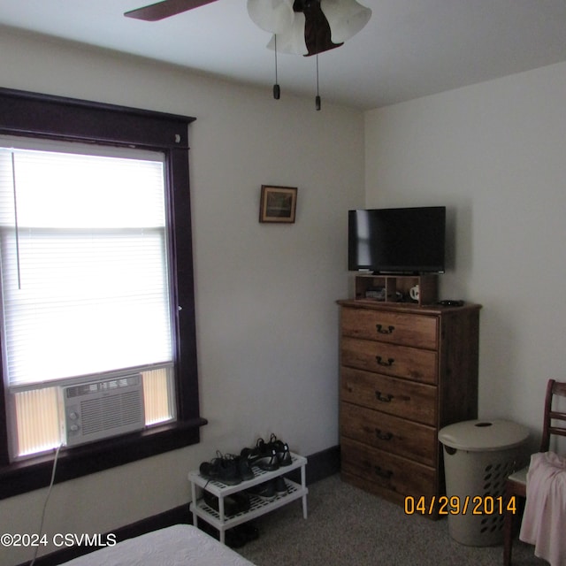 bedroom with ceiling fan, carpet floors, and cooling unit