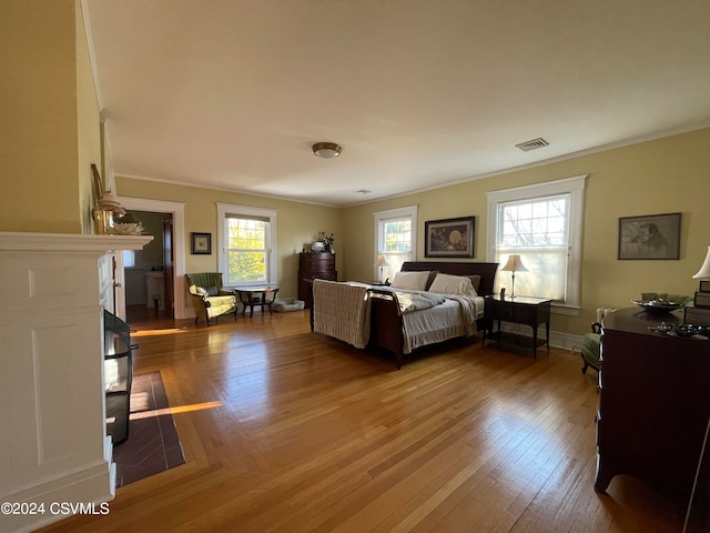 bedroom with hardwood / wood-style flooring and ornamental molding