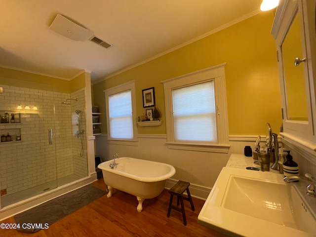 bathroom with sink, plus walk in shower, wood-type flooring, and crown molding