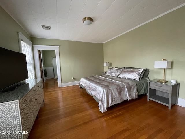 bedroom with hardwood / wood-style floors and crown molding