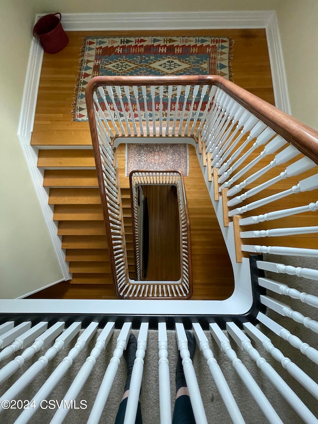 stairway featuring hardwood / wood-style floors