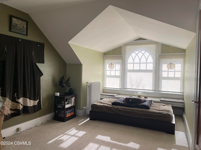 carpeted bedroom with radiator and vaulted ceiling