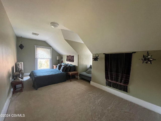 carpeted bedroom with vaulted ceiling