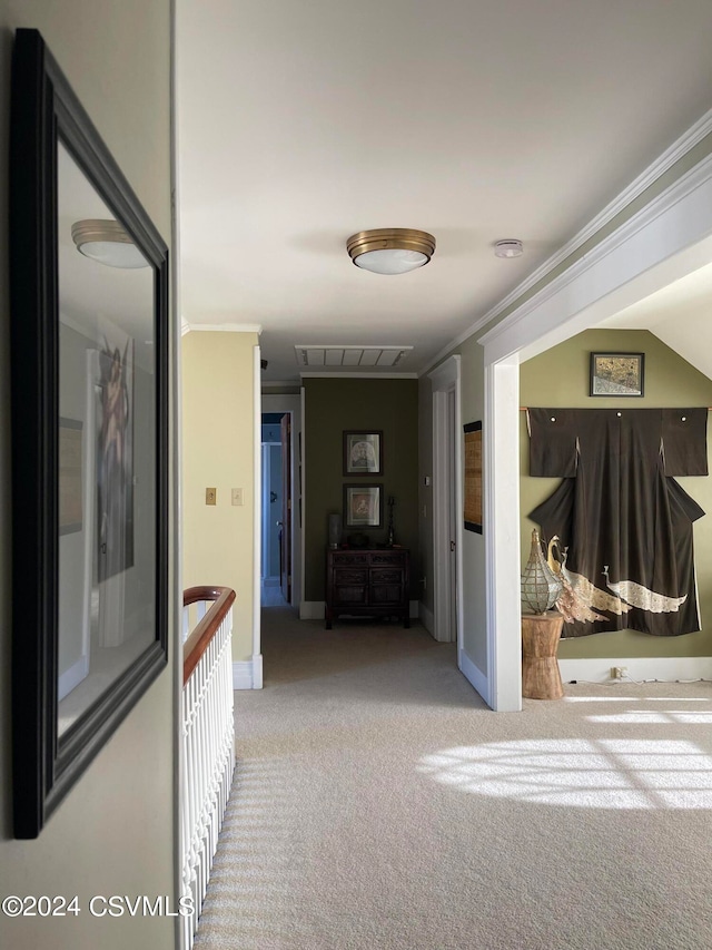 hall with ornamental molding and light carpet