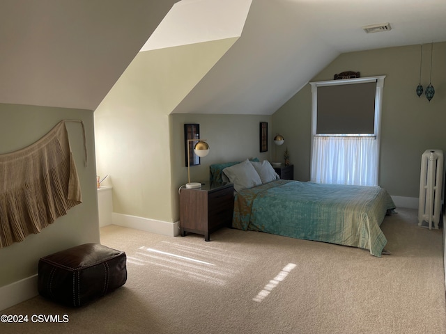 bedroom featuring radiator, light colored carpet, and lofted ceiling