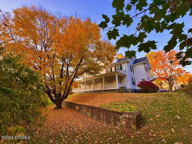 back of property featuring a porch