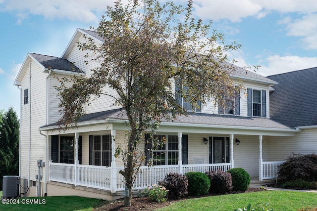 view of front of home featuring cooling unit and a porch