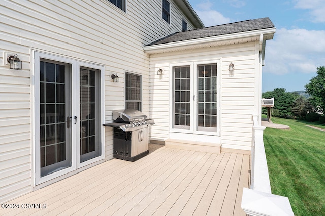 wooden terrace with area for grilling, french doors, and a yard