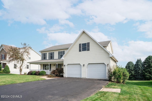 view of front property featuring a garage and a front lawn