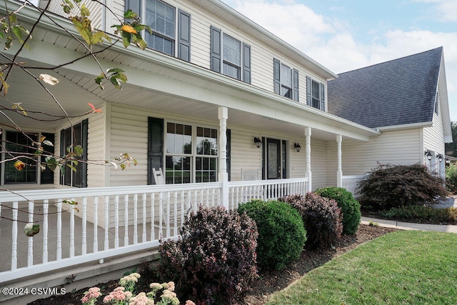 view of side of property with a porch