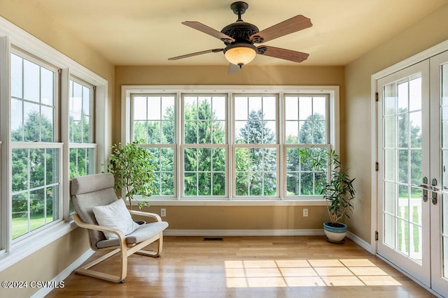 sunroom / solarium featuring ceiling fan and plenty of natural light