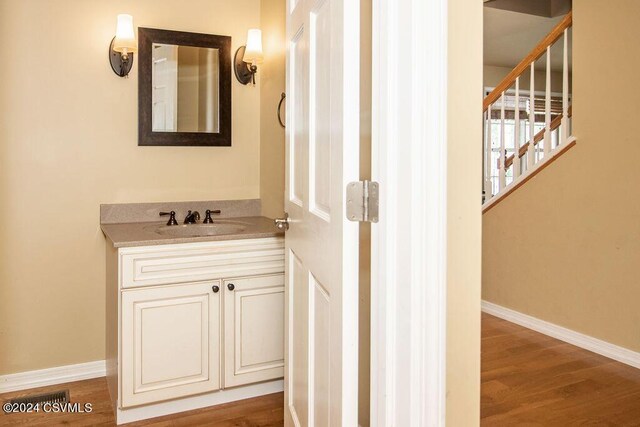 bathroom featuring vanity and hardwood / wood-style floors