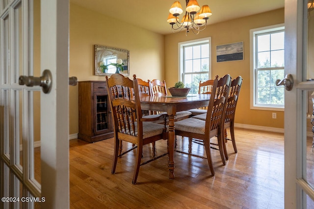 dining room featuring light hardwood / wood-style floors and a chandelier