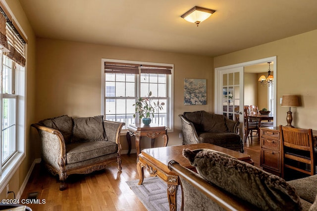 living room featuring hardwood / wood-style flooring and a notable chandelier