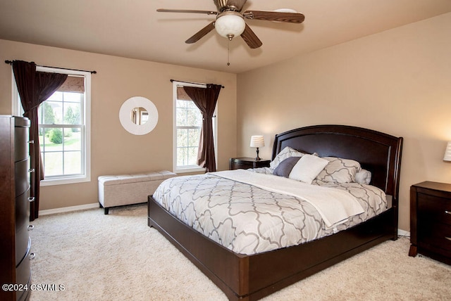 carpeted bedroom with multiple windows and ceiling fan