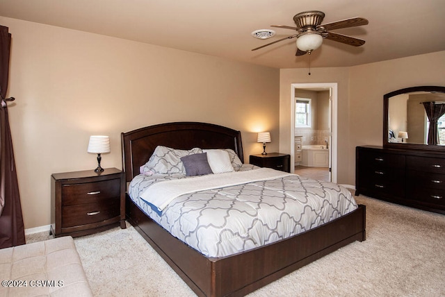 carpeted bedroom with ceiling fan and ensuite bathroom