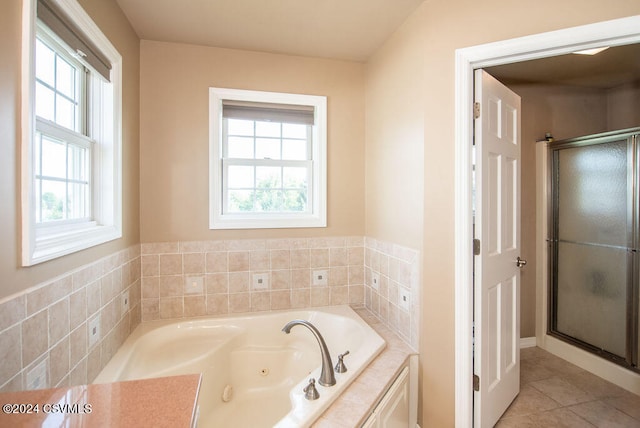 bathroom featuring independent shower and bath and tile patterned flooring