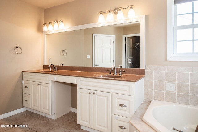 bathroom featuring tiled bath, tile patterned flooring, and vanity