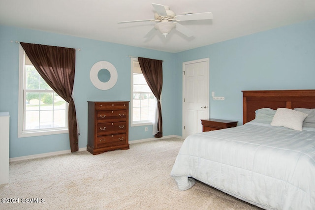 bedroom with carpet floors, ceiling fan, and multiple windows