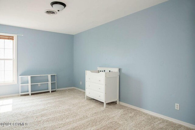 unfurnished bedroom with multiple windows and light colored carpet