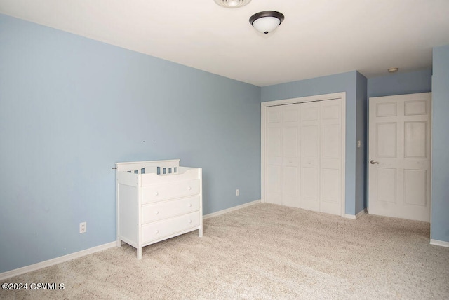 unfurnished bedroom with a closet and light carpet