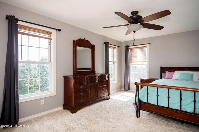 bedroom with ceiling fan and light carpet