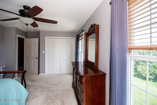 bedroom featuring ceiling fan, a closet, and carpet