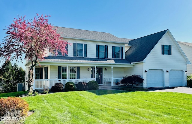 66 Meixell Cir, Lewisburg, PA 17837 - view of front facade with a porch, a garage, a front yard, central air condition unit, and asphalt driveway