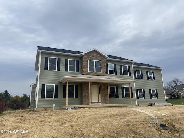 view of front of home featuring stone siding and a porch