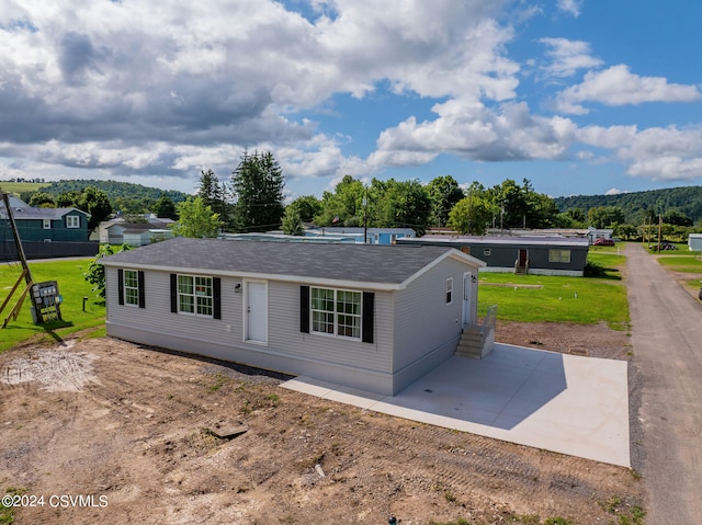 single story home with a patio and a front yard