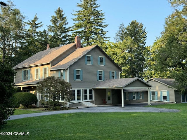 back of property featuring a lawn