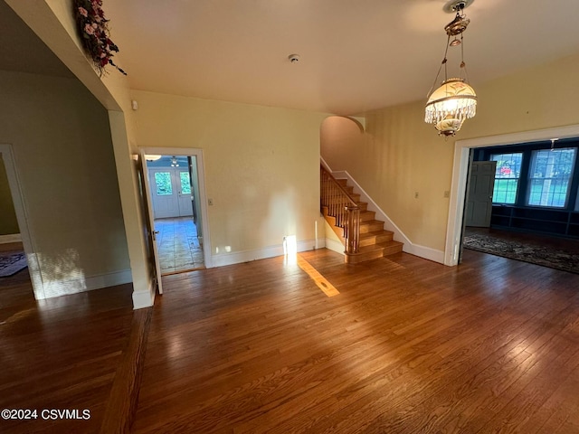 unfurnished living room featuring dark hardwood / wood-style flooring