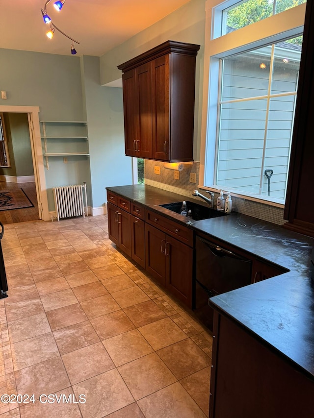 kitchen with tasteful backsplash, radiator, dishwasher, dark brown cabinetry, and sink